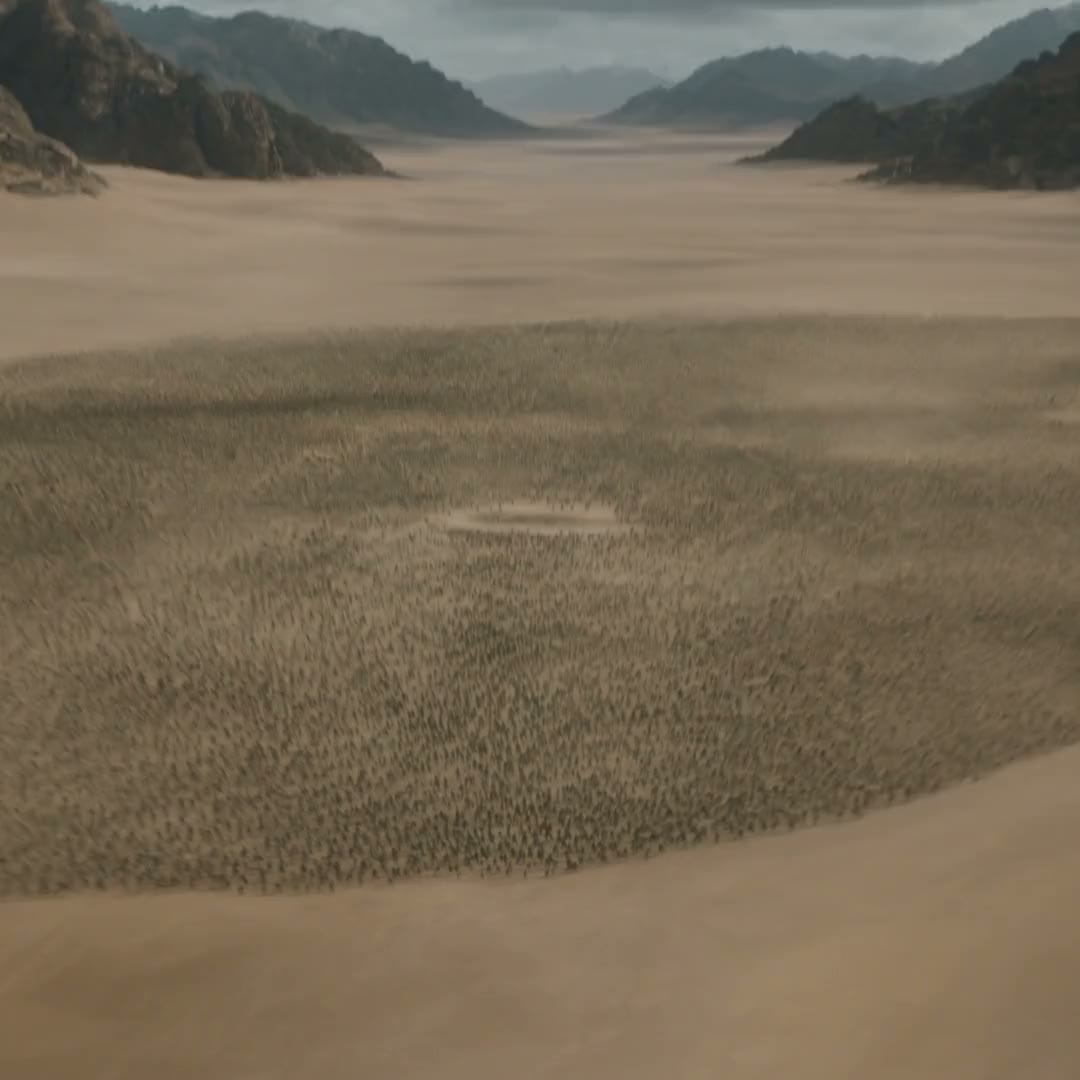 A vast desert army between mountain ranges